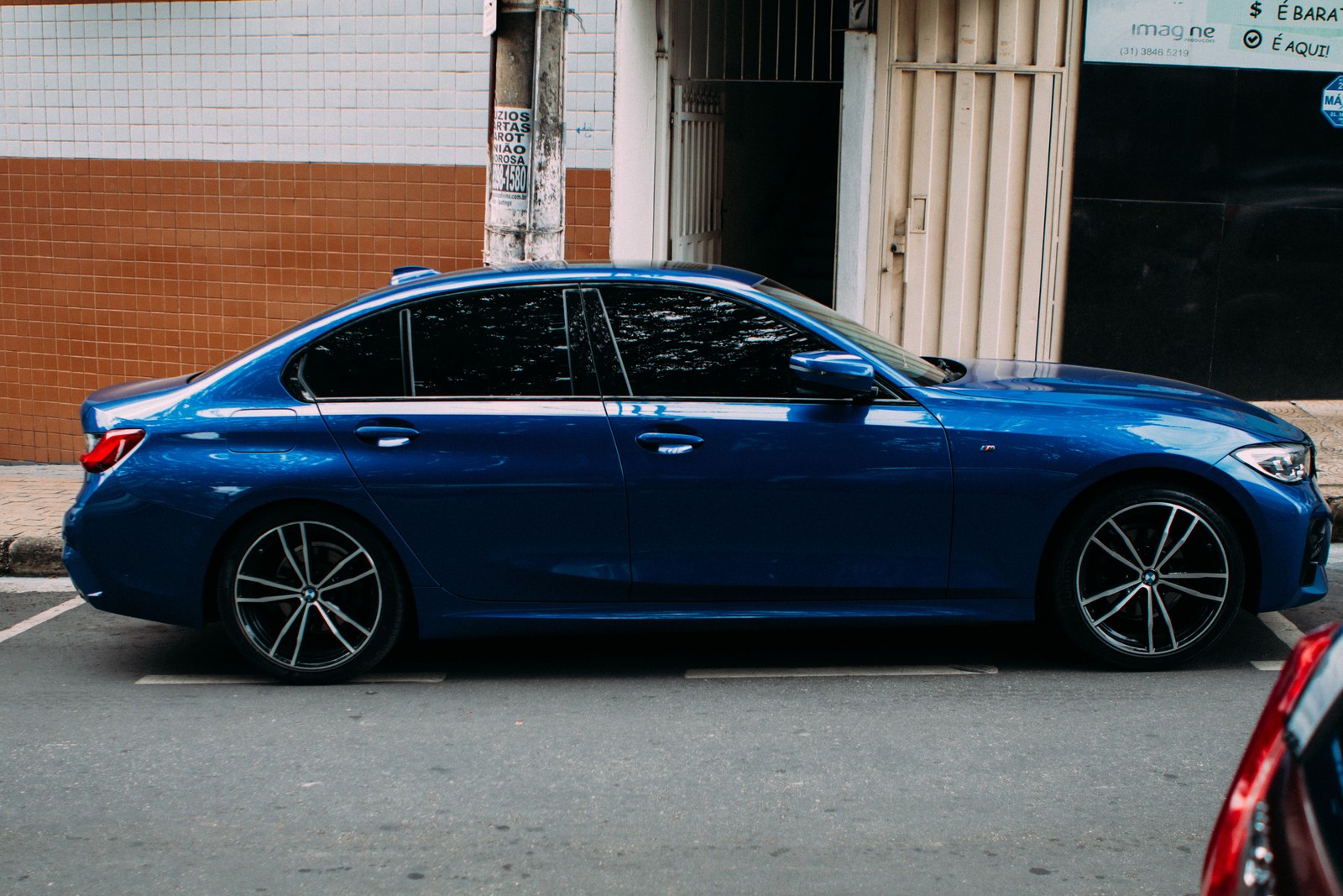 Tinted BMW parked on a city street